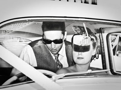 Scene from the 50s Celebrity Couple in a car blinded by a firing camera flash Ballarat Wedding Photography Lydiard Street