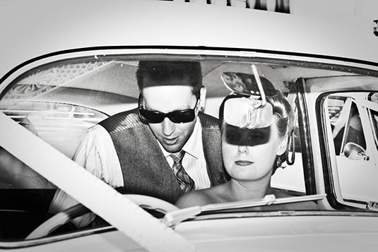 Scene from the 50s Celebrity Couple in a car blinded by a firing camera flash Ballarat Wedding Photography Lydiard Street