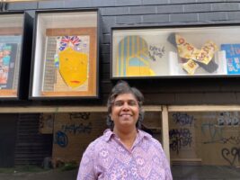 Artist Bratdevi standing in front of her Unicorn Lane exhibition.