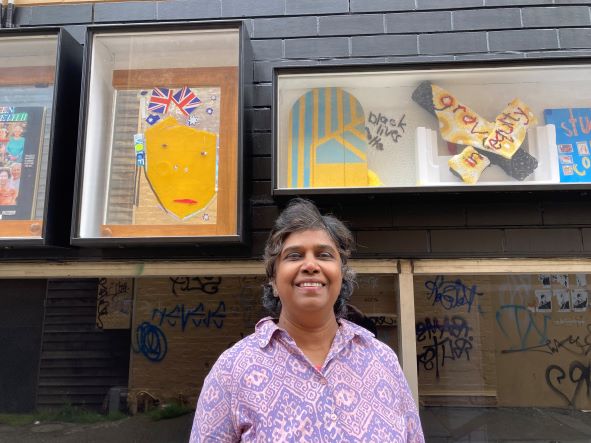 Artist Bratdevi standing in front of her Unicorn Lane exhibition.