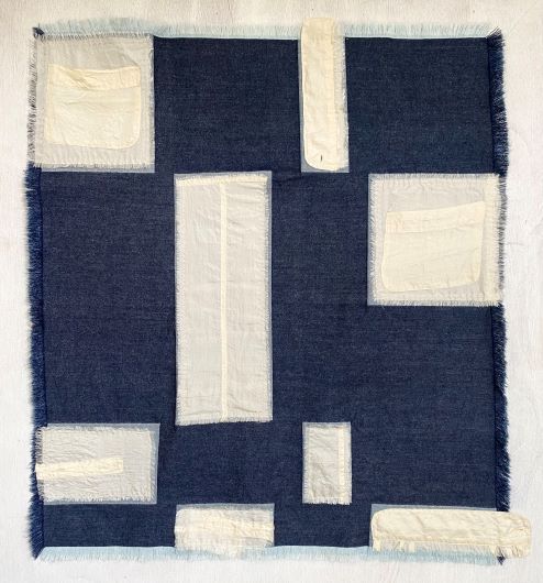 Textile artwork made from cotton and silk in white and nave blue squares and rectangles.